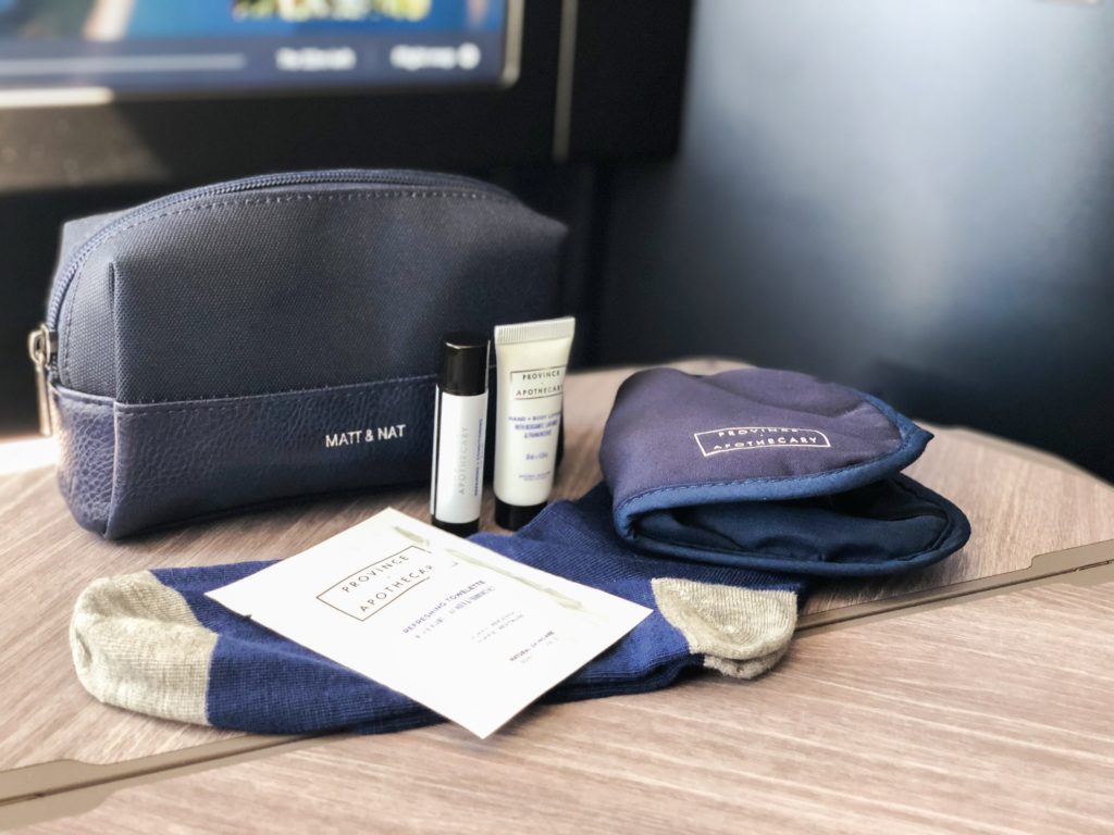 Business class guests departing to Canada receive navy blue-coloured amenity kits designed by Montreal's Matt & Nat