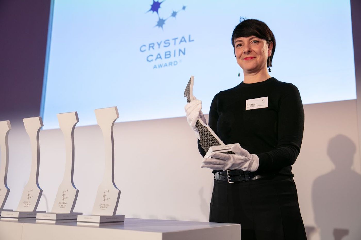 Carmen Krause is project director of the Crystal Cabin Awards holding a trophy