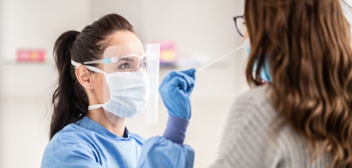 a female being given a Covid-19 swab test by a female doctor