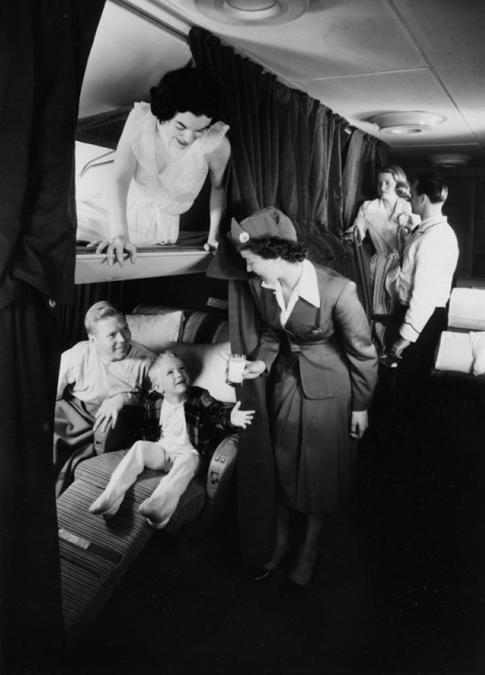 A black and white image showing bunk beds in a Boeing 377 Stratocruiser